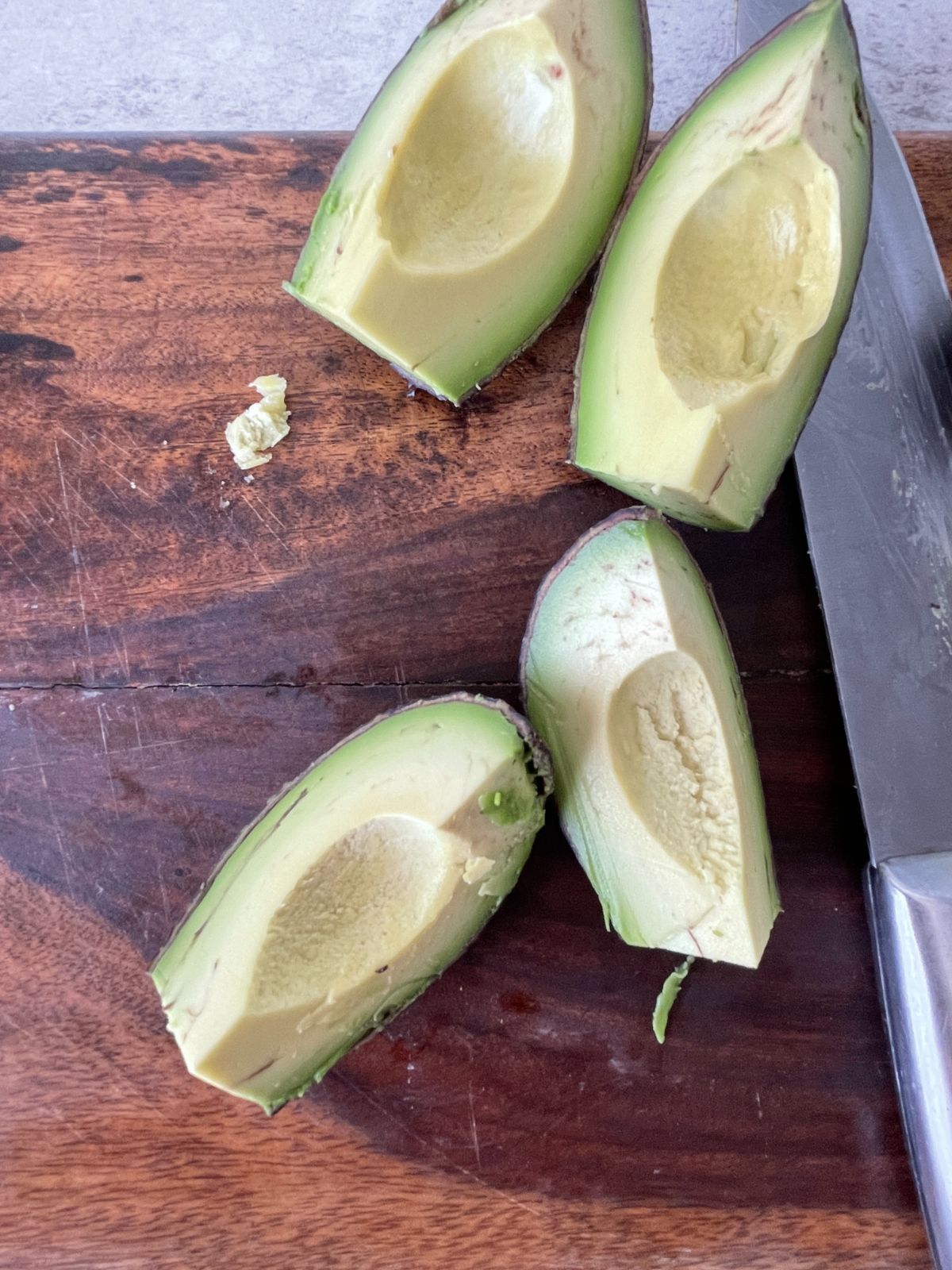 sliced avocados on a chopping board