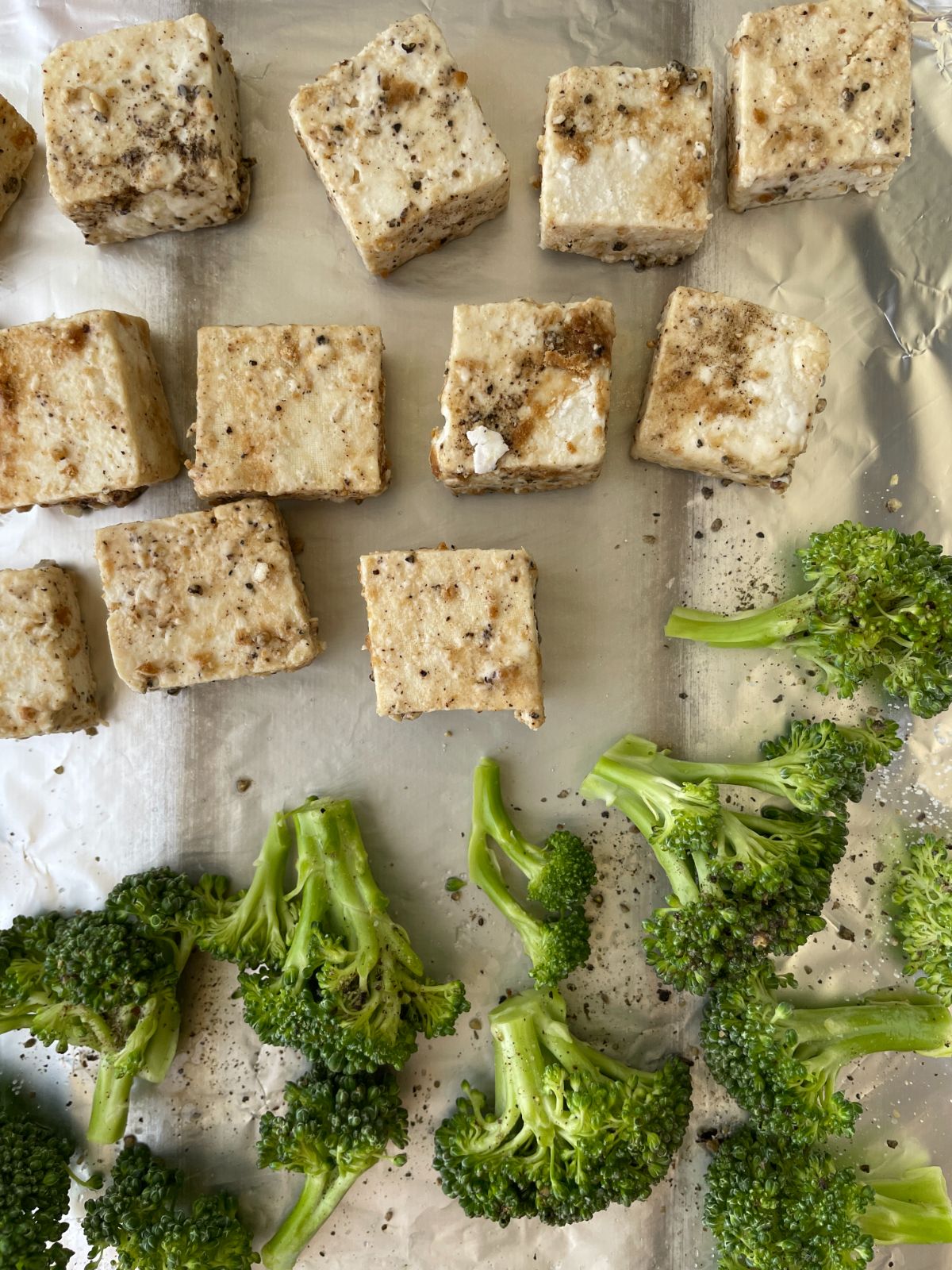 bake coated tofu pieces and broccoli florets in an aluminum foil
