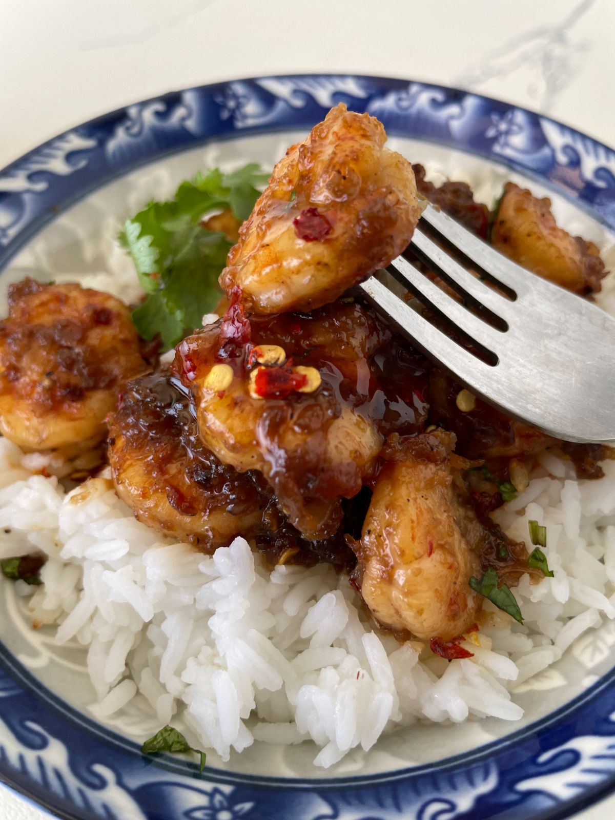 Honey Sriracha Shrimp Rice Bowl on a plate with fork