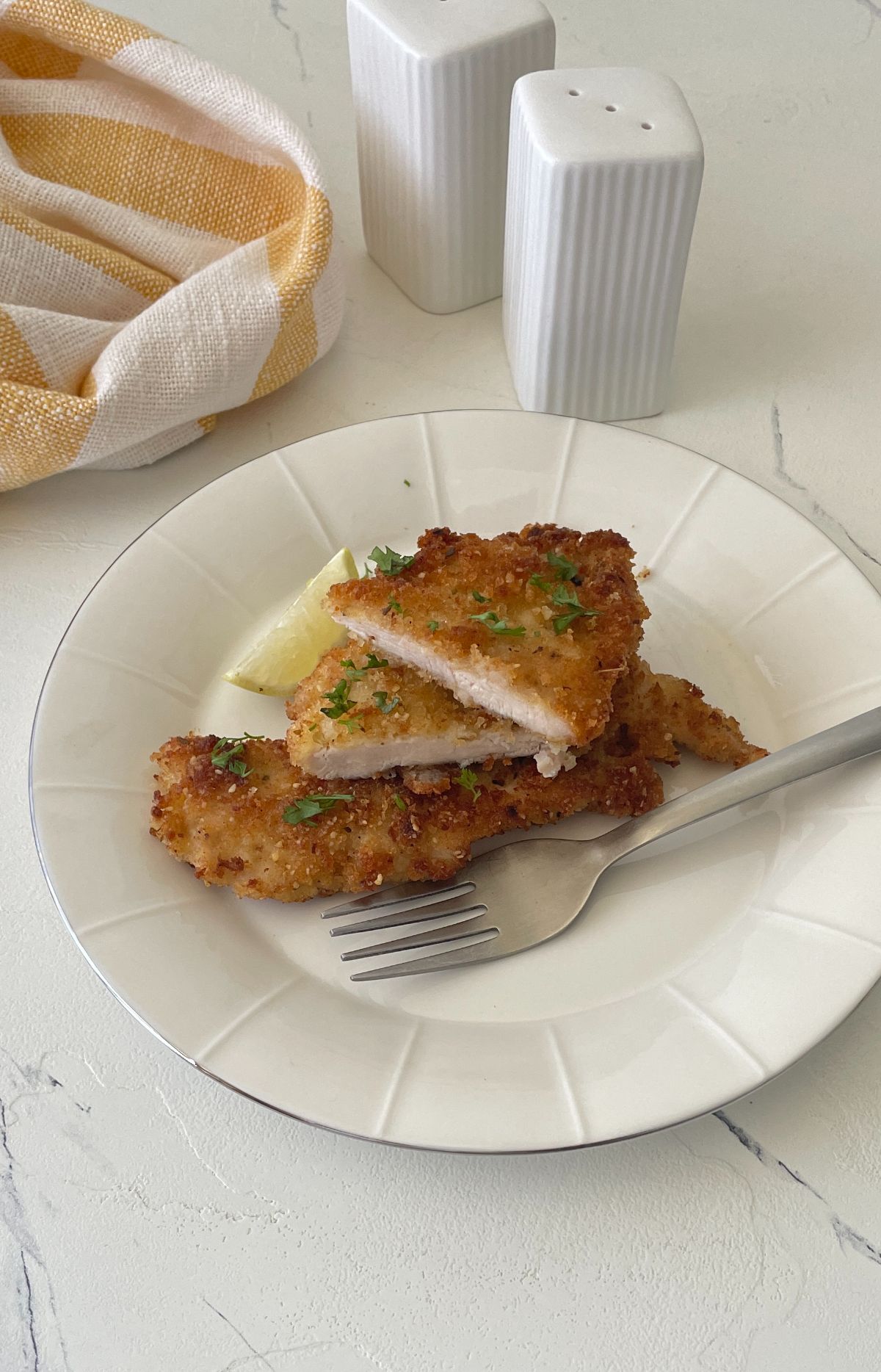 pieces of Italian Chicken Cutlets with fork