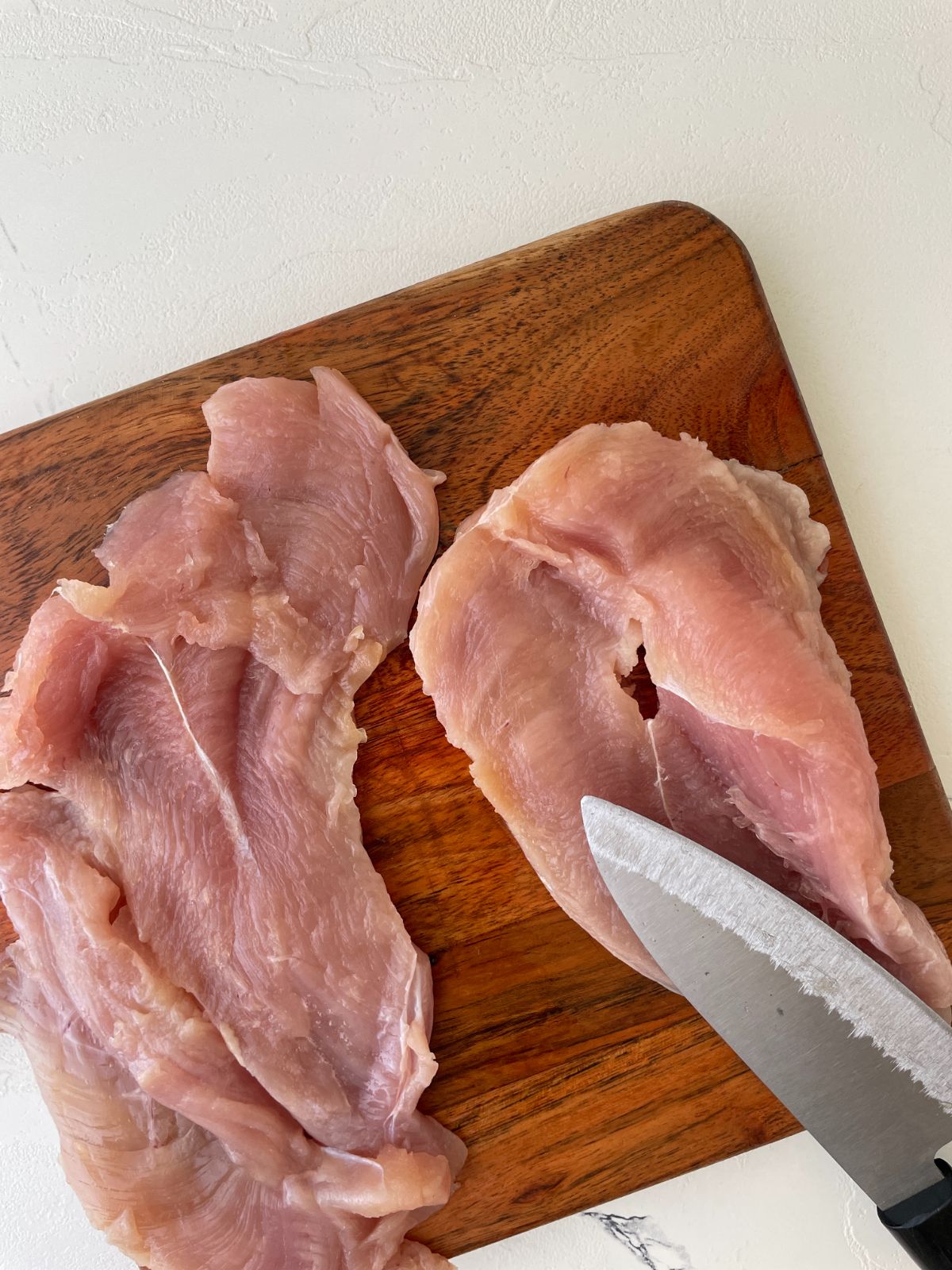 cut the pieces of chicken breast horizontally 