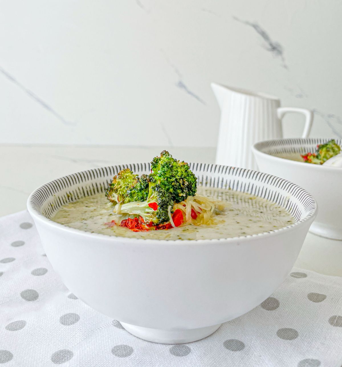 side view of Vegetarian Broccoli Cheddar Soup in a bowl 