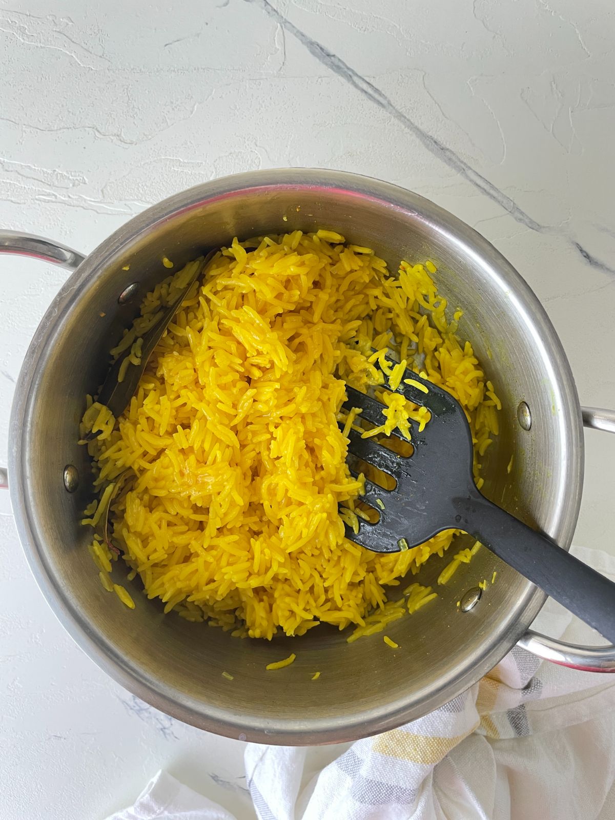 garlic turmeric rice being cooked in a pot