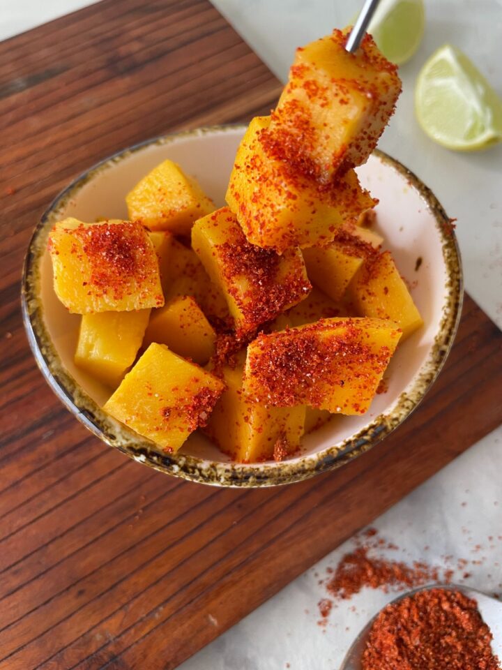 mango con tajin served in a bowl