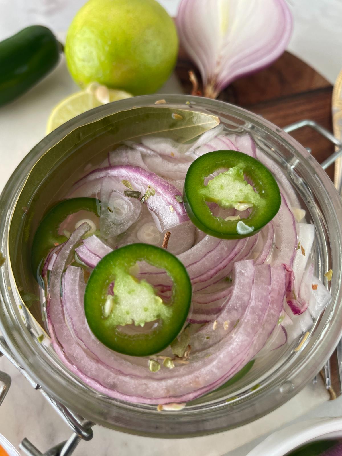 lime pickled onions in a glass jar