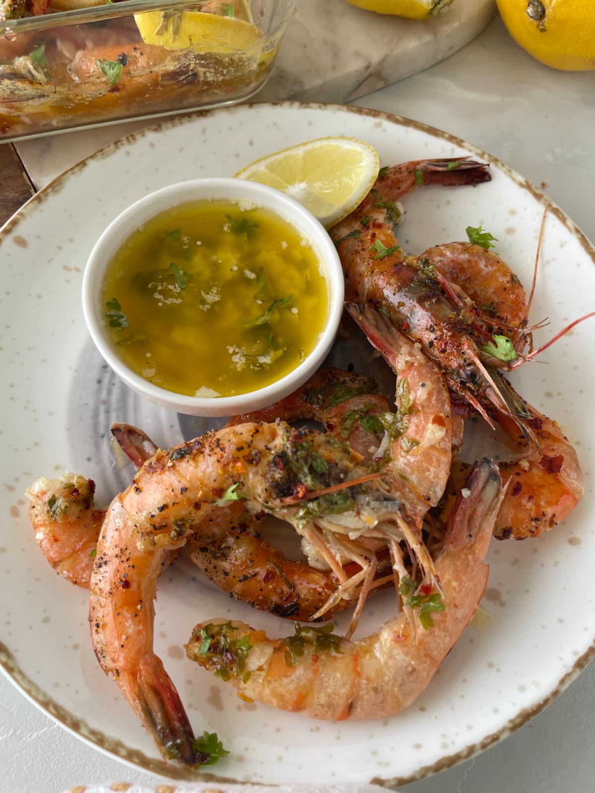 freshly baked garlic lemon butter shrimp served with garlic butter on the side