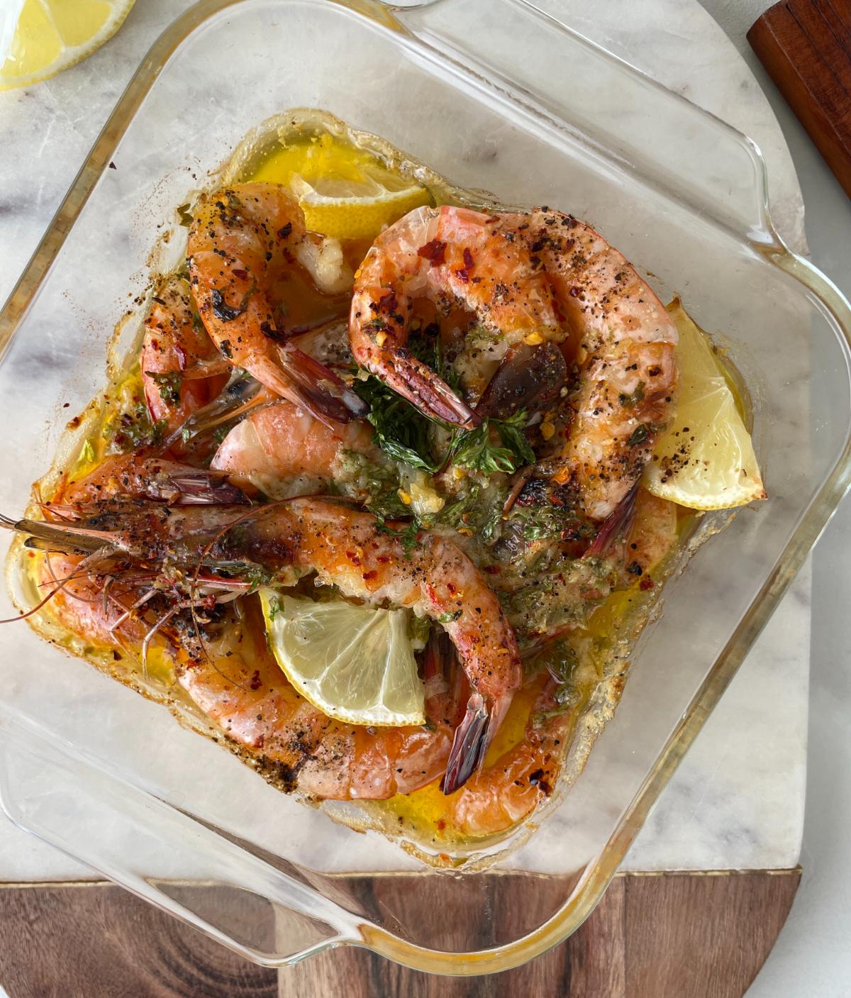 freshly baked garlic lemon butter shrimp in a baking dish