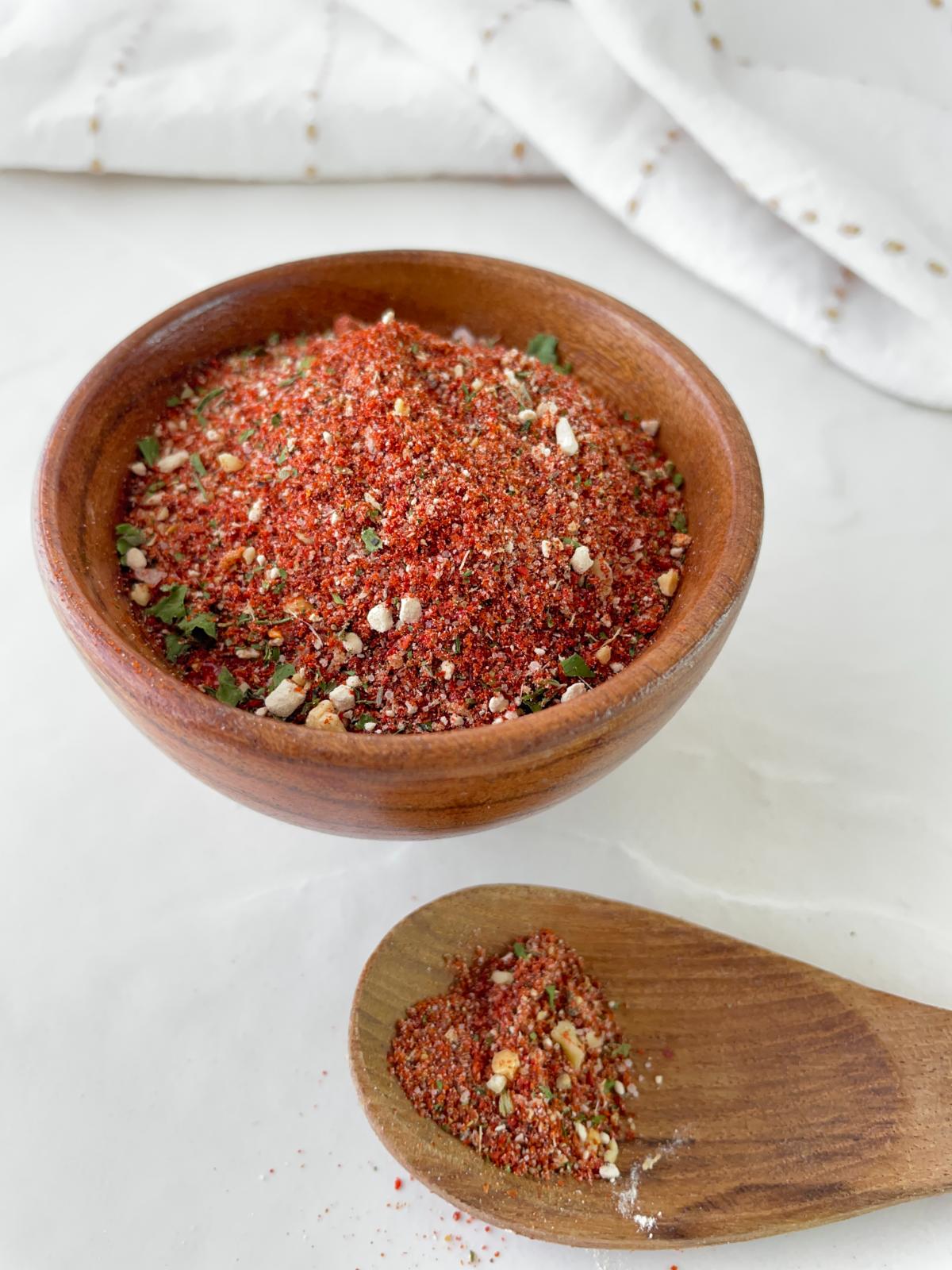 homemade peri peri seasoning mix in a small bowl and spoon