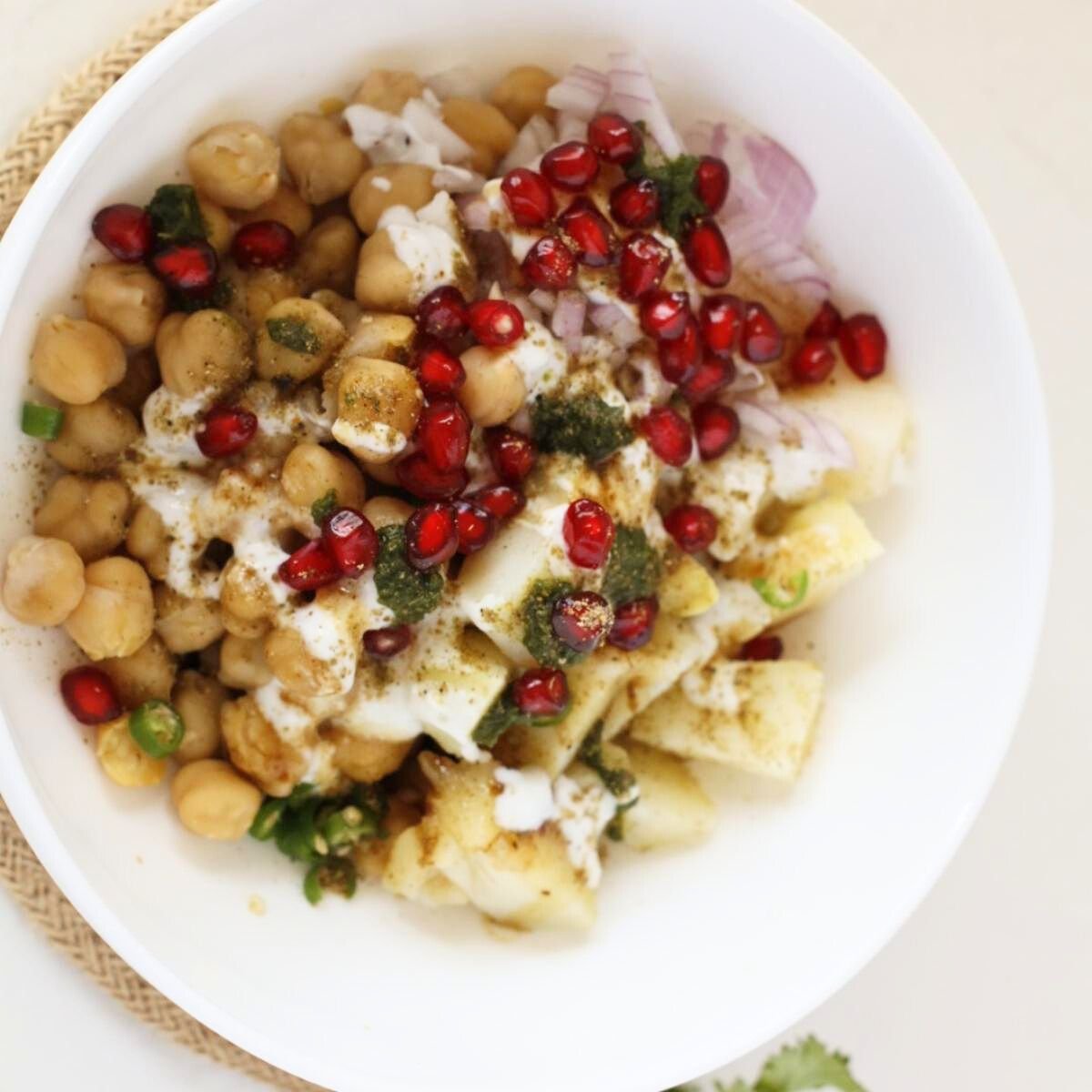 sprinkle some chaat masala, pomegranate and cilantro over the chickpea mixture