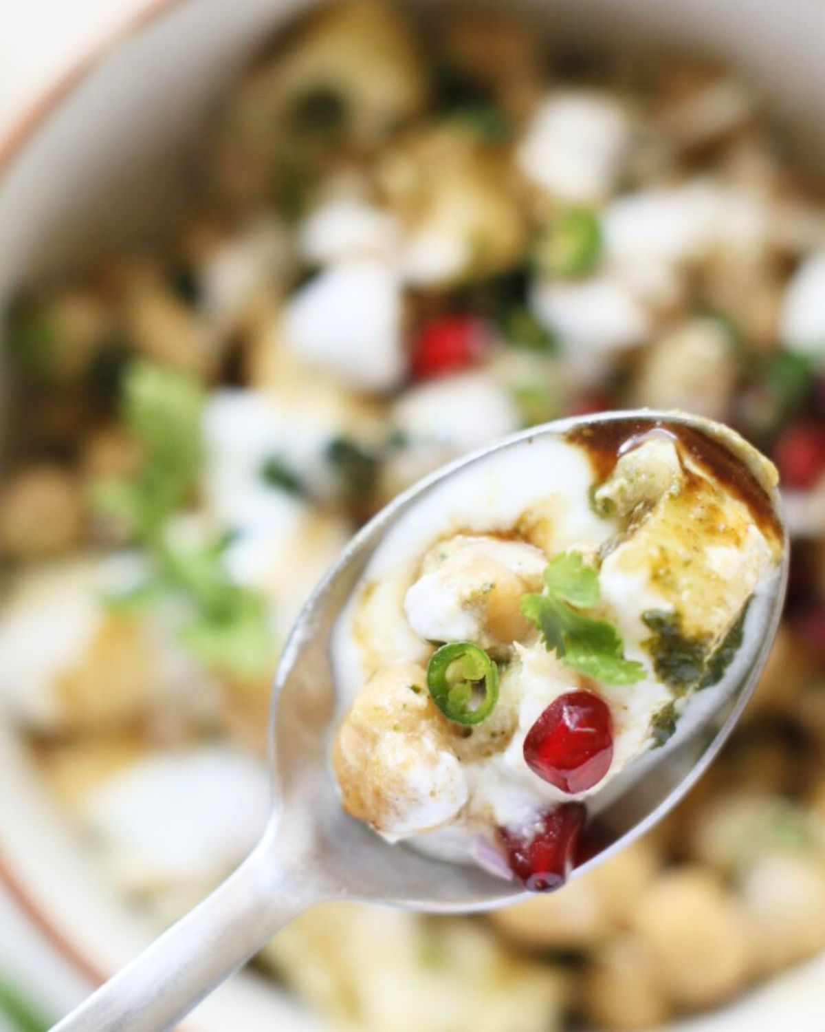 A bite of Dahi Chana Chaat in spoon