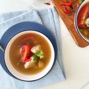 bowls of tom yum gai soup, garnished with cilantro