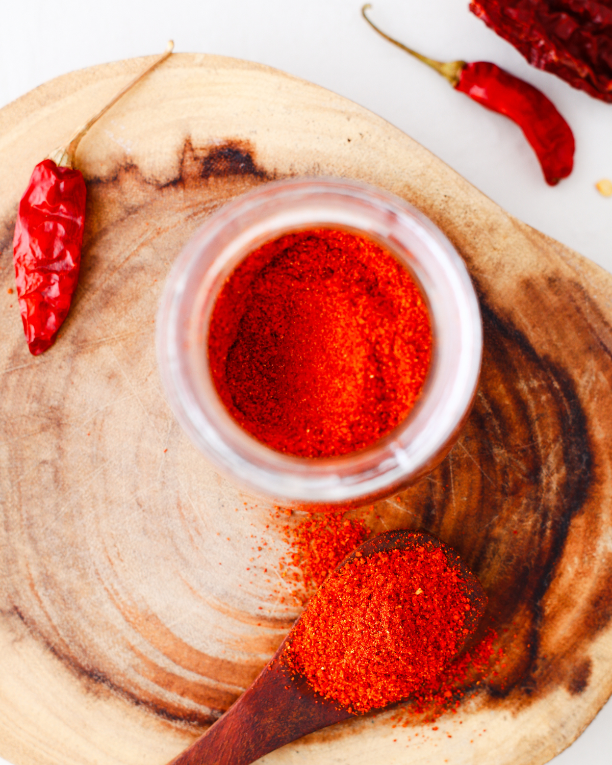 homemade tajin in a small glass jar on a wooden surface