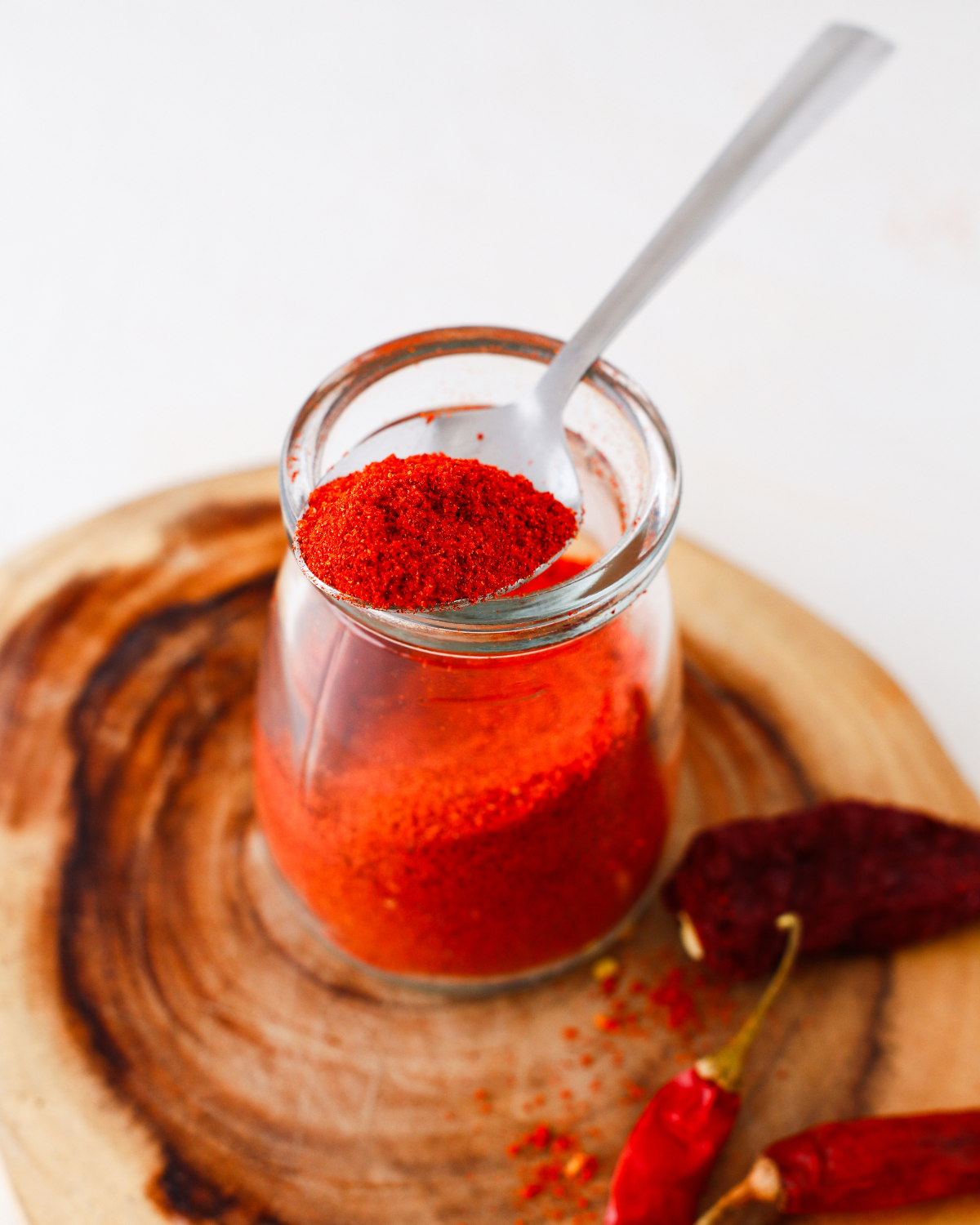 a spoonful of homemade tajin spice mix on a jar full of the seasoning