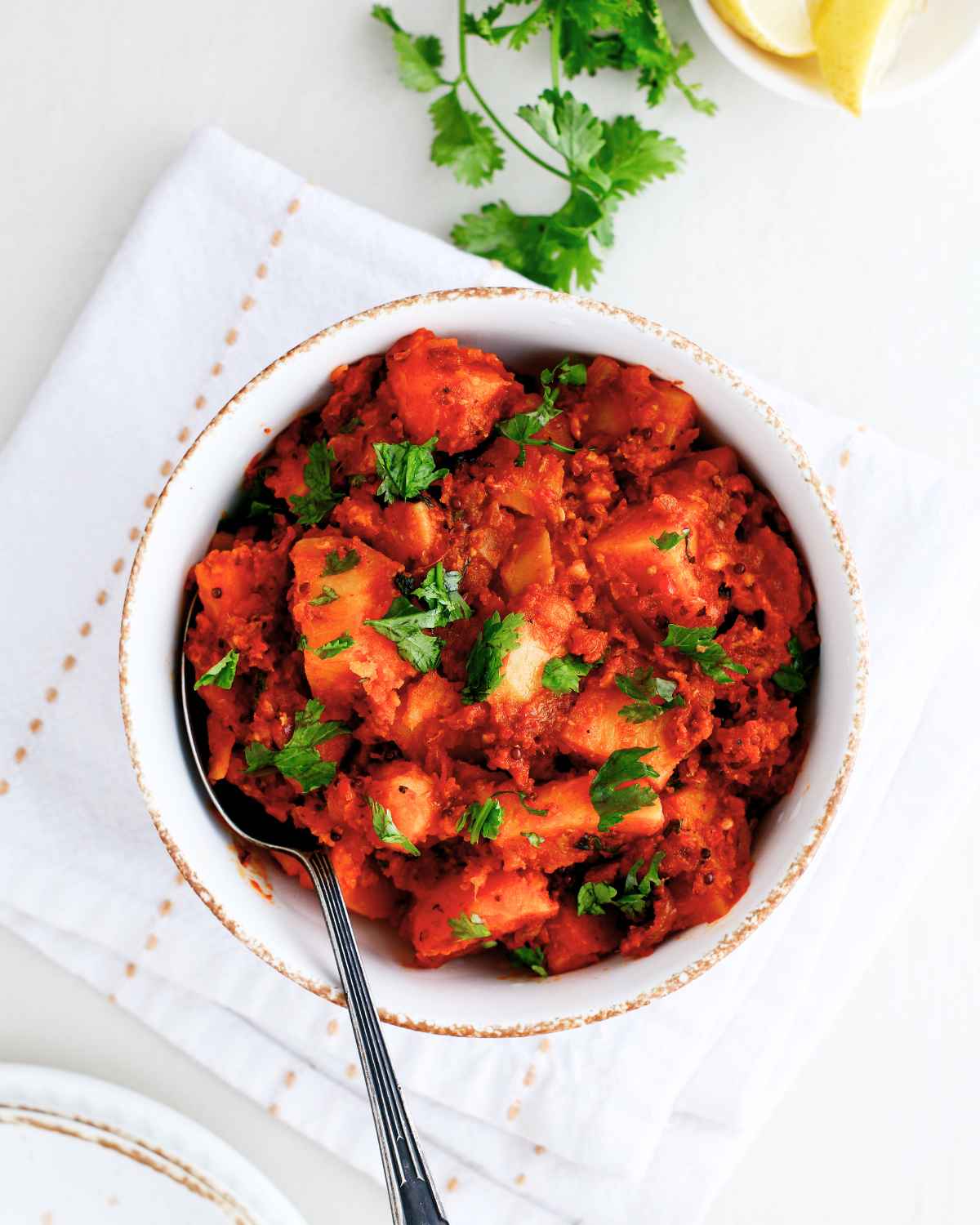 Spicy and tasty Potato Vindaloo in a bowl with a spoon