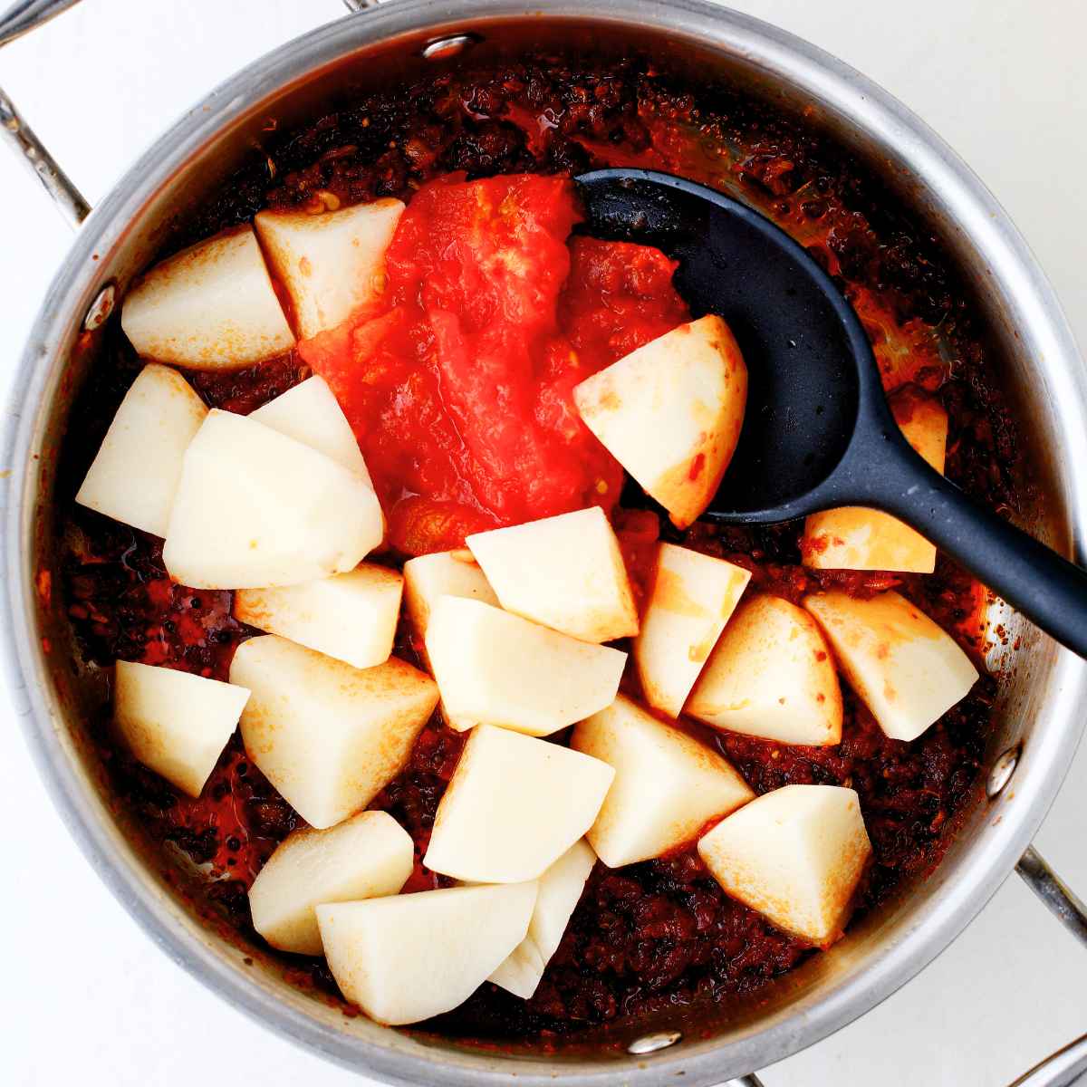 add some canned tomatoes in the pan and cook