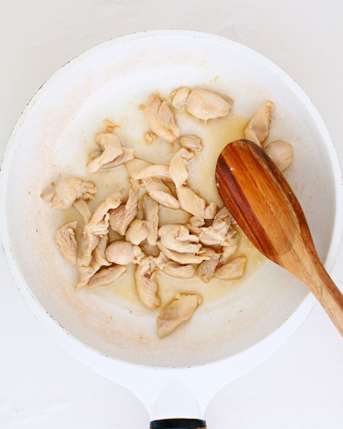 Chicken strips cooking in a pan