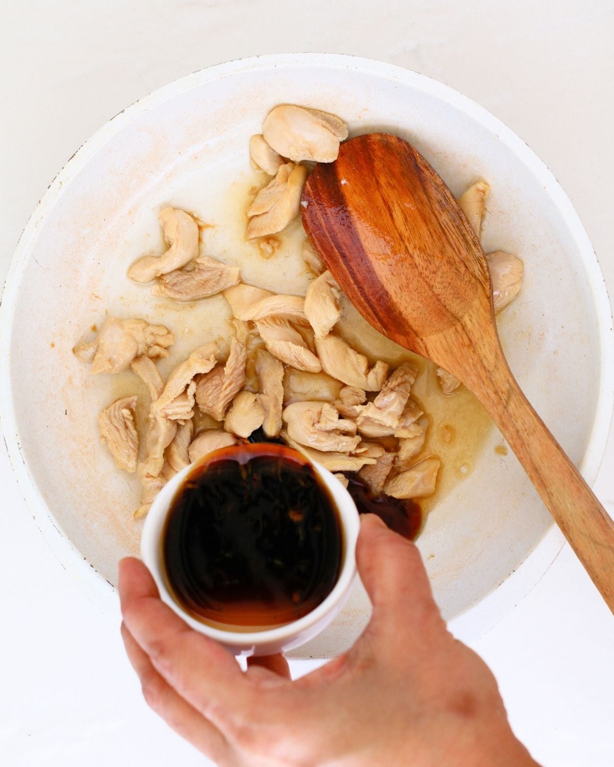 Teriyaki sauce being added to chicken