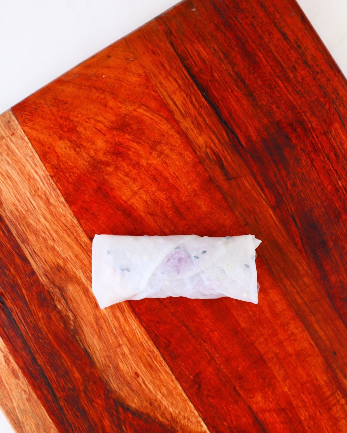 Wrapped chicken rice paper dumpling on a board