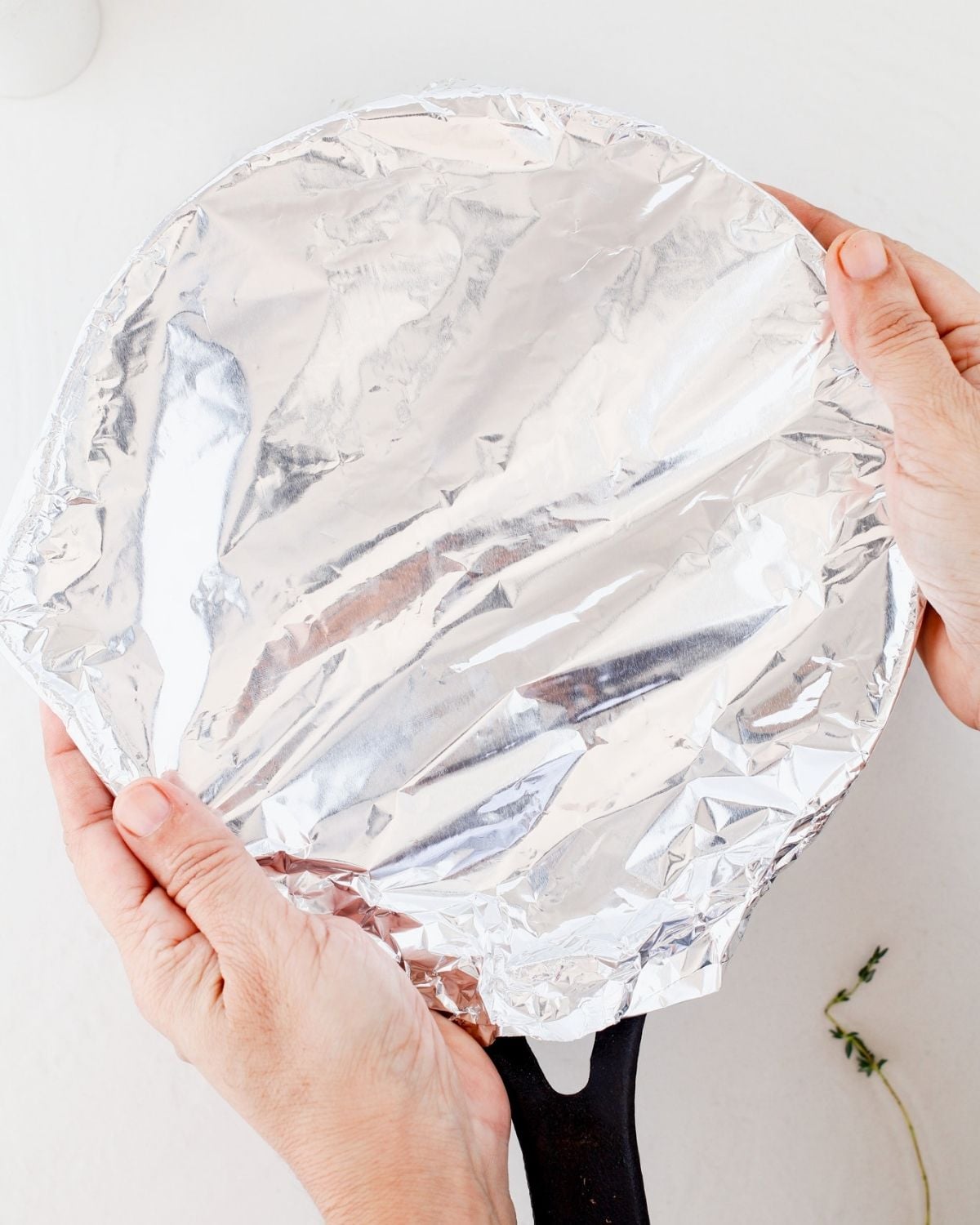 Skillet of potatoes covered with foil