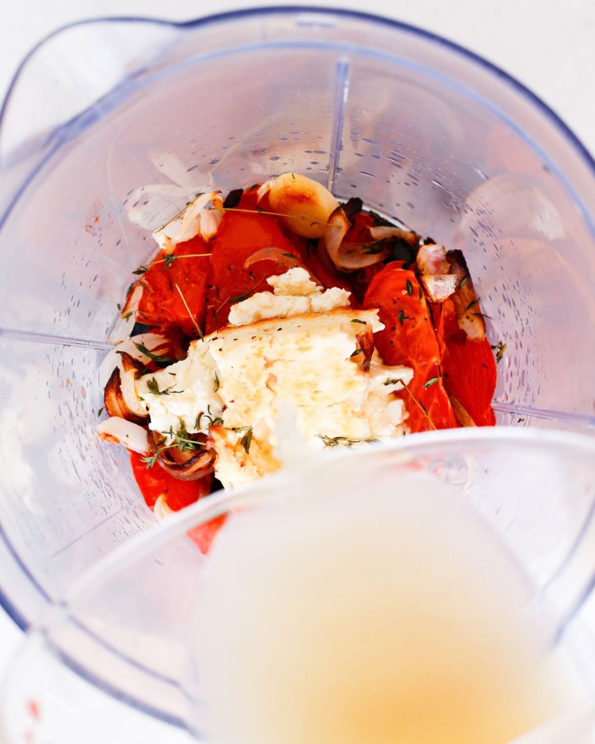 Roasted vegetables and feta transferred to a blender